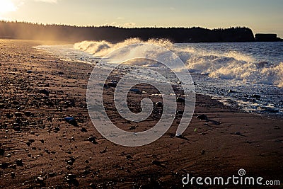 Sunrise crashing waves high winds rising tide Stock Photo