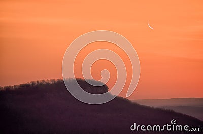 Sunrise with a crescent moon Stock Photo