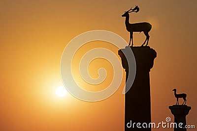The deer statues at the entrance to Rhodes harbor at sunrise Stock Photo
