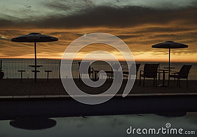 Sunrise far from the swimming pool with gold morning clouds Editorial Stock Photo
