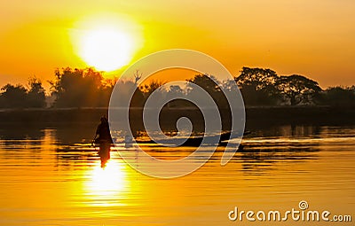 Sunrise fisherman and dinghy Stock Photo