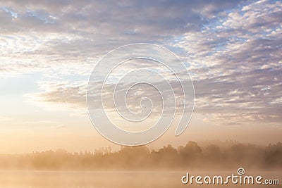 Sunrise at foggy lake Stock Photo