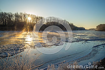 Sunrise during freeze-up in the river Stock Photo