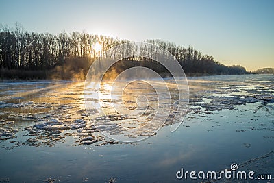 Sunrise during freeze-up in the river Stock Photo