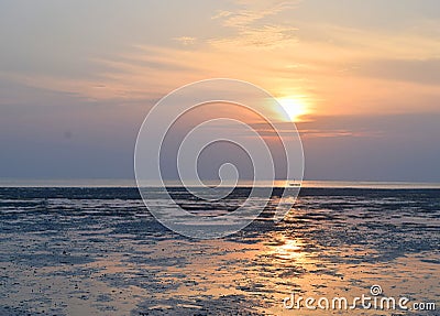 Sunrise with Golden Sun and its Reflection in Water and Colorful Sky - Vijaynagar Beach, Havelock Island, Andaman, India Stock Photo