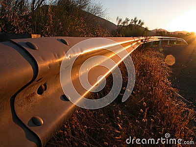 Sunrise on a guardrail Stock Photo