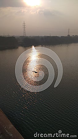 Sunrise high tension towers and water Stock Photo