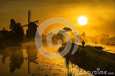 Sunrise hunter walking toward the sun Stock Photo