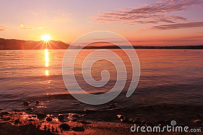Sunrise by a lake inspiring relax and quietness Stock Photo