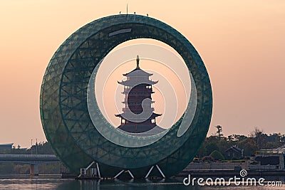 Sunrise landscapes with a Chinese traditional pagoda and moon like architecture building on lake, in Xinglin Bay, Xiamen, China Stock Photo