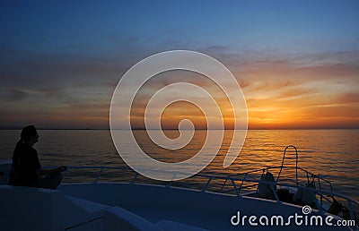 Sunrise meditation on the boat Stock Photo