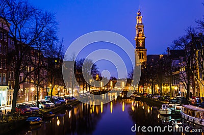 Morning blue sunrise on Amsterdam canal with Church bell tower on the background horizon Editorial Stock Photo