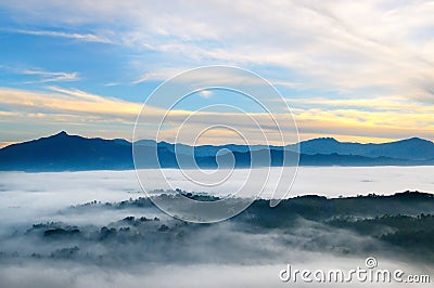 Sunrise in mountains, fog and cloud mountain valley landscape Stock Photo