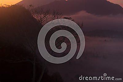 Sunrise in the mountains. Nature abstract art background. Misty morning in the mountain view backgrounds in light orange and dark Stock Photo