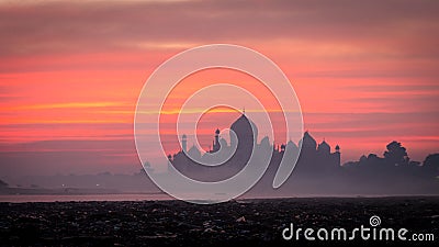 Sunrise with mystic foggy sky taj mahal Stock Photo