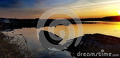 Sunrise Old ship wrecks on the river Plym Stock Photo