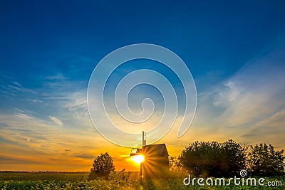 Sunrise and an Old Wooden Windmill Stock Photo