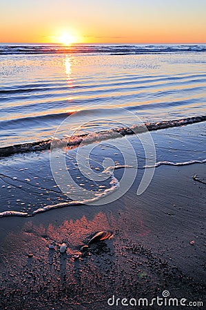 Sunrise over calm ocean Stock Photo