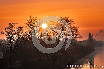 Sunrise over a channel in Berlin on a misty morning with fairytale sunlight Stock Photo