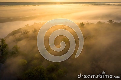 Sunrise over foggy riverbank. Fog on river aerial view. Misty river in sunlight from above Stock Photo