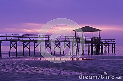 Sunrise over the Gulf of Mexico with pier in Biloxi, MS Stock Photo