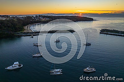 Sunrise over the harbour with low cloud bank and boats Stock Photo