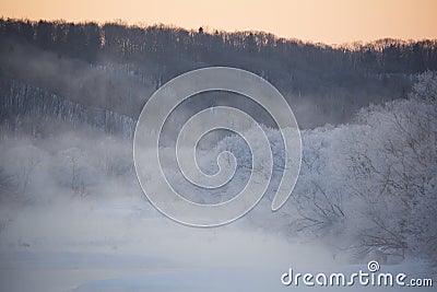 Sunrise over a Hazy, Frigid Winter River Landscape Stock Photo