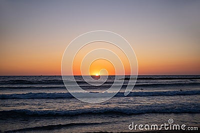 Sunrise over sea, view from beach to open sea and horizon, new day dawning. Stock Photo