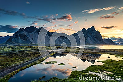 Sunrise over Vestrahorn mountain with wilderness and lake reflection in summer at Stokksnes peninsula Stock Photo