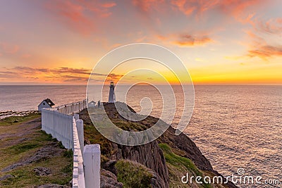 Sunrise over a white lighthouse at Cape Spear National Historic Site, St Johns Newfoundland. Stock Photo
