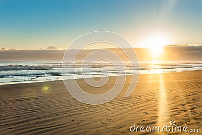 Sunrise over wide flat sandy beach at Ohope Whakatane Stock Photo