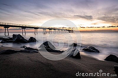 Sunrise on the Pont del petroli beach with silky water. Stock Photo