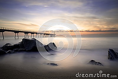 Sunrise on the Pont del petroli beach with silky water. Stock Photo