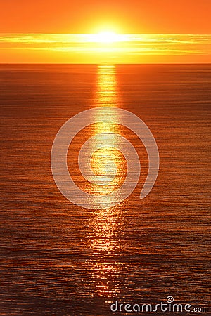 Sunrise reflected on the ocean Stock Photo