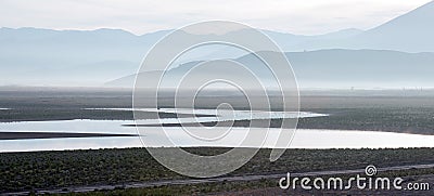 Sunrise reflections on drought stricken Lake Isabella in the southern Sierra Nevada mountains of California Stock Photo