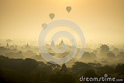 Sunrise scene hot air balloons fly over pagoda ancient city field in Bagan Myanmar.High image quality Stock Photo