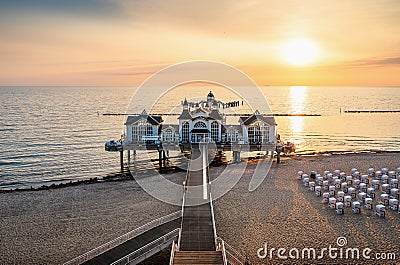 Sunrise scenery at famous Sellin SeebrÃ¼cke Pier in beautiful golden morning light Stock Photo