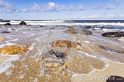 Sunrise on the sea - Sea wave crash on big stone in beautiful white splashes. Seascape. Panoramic view of the seashore Stock Photo