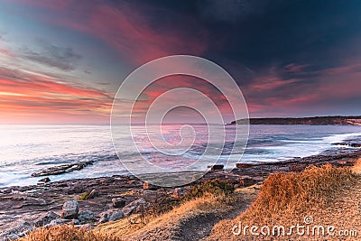 Colourful Sunrise Seascape with Pink Clouds Stock Photo