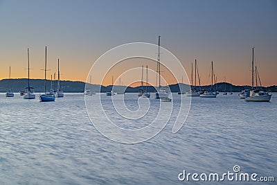 Sunrise and Silhouettes, Boats on the Bay Stock Photo