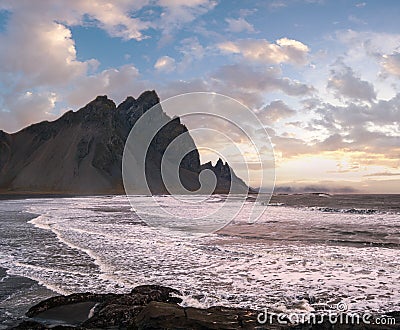 Sunrise Stokksnes cape sea beach and Vestrahorn Mountain with and ocean surf. Amazing nature scenery, popular travel destination Stock Photo