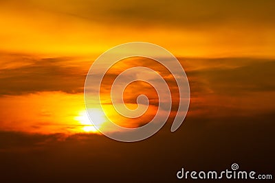 Sunrise-Sunset with clouds, light rays and other atmospheric effect.Brilliant orange sunrise over clouds with bright yellow sun on Stock Photo