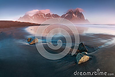 Sunrise at Vestrahorn Stokksnes Mountain Range with Brunnhorn Mountain also visible in the distance. Iceland. Seascape Stock Photo