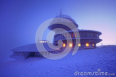 Sunrise view of Pec pod Snezkou in the Krkonose Mountains in winter. Czech Republic. Morning panoramic view above clouds. Stock Photo