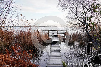 Sunrise wooden pontoon jetty lake water wild coast Stock Photo