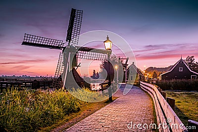 Sunrise Zaanse Schand Dutch windmill village, Windmill village Zaanse Schans, green wooden house at the windmill village Stock Photo