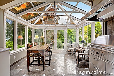 Sunroom patio area with transparent vaulted ceiling Stock Photo