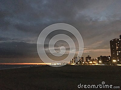 Sunset above Coney Island Boardwalk - View from Brighton Beach in Brooklyn, New York, NY. Stock Photo