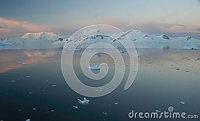 Sunset and alpenglow, mountains and mirror - calm ocean Stock Photo