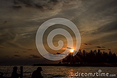 Sunset with angler Stock Photo